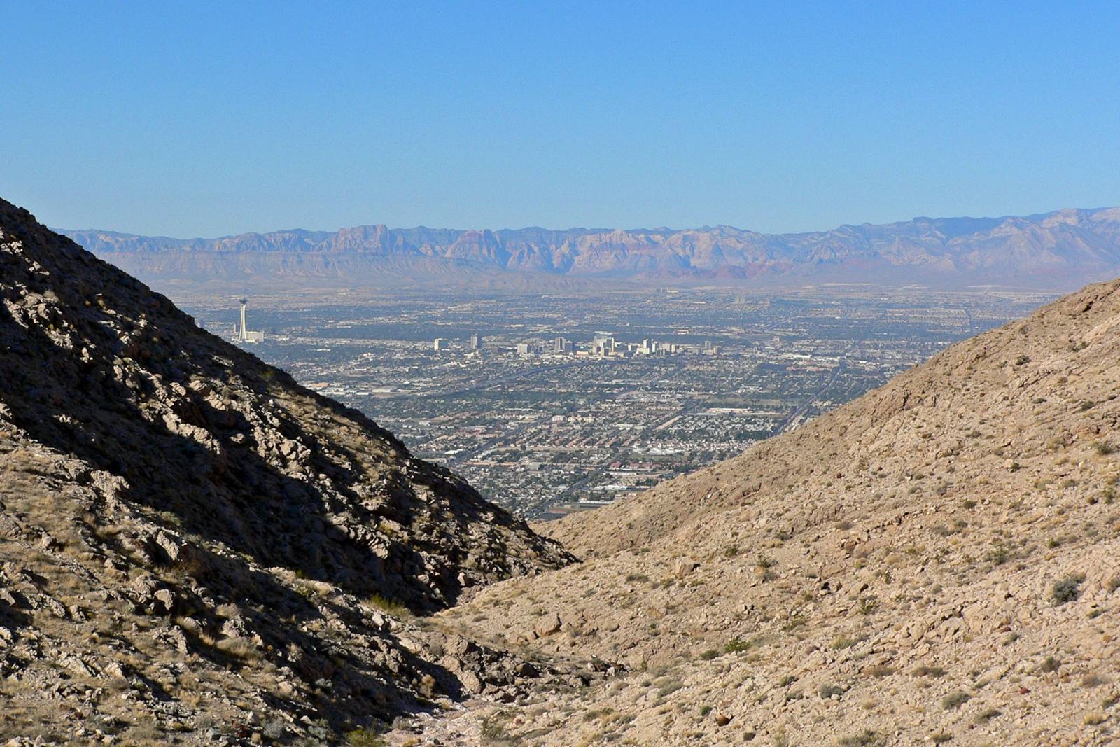 The Las Vegas Valley seen through a canyon notch on Frenchman Mountain, with downtown and the Spring Mountains beyond